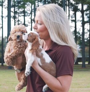 Woman holding two puppies